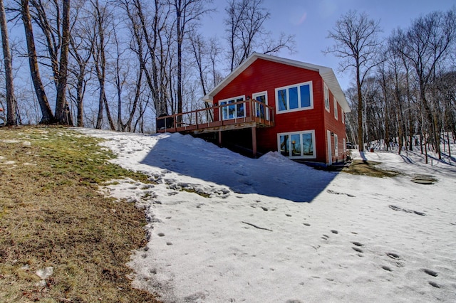 snow covered property with a wooden deck