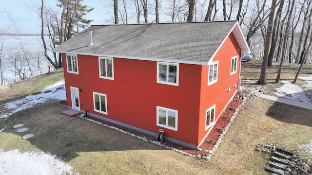 view of side of property with a shingled roof