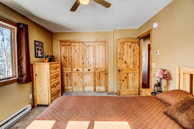 carpeted bedroom with a ceiling fan, baseboards, and a baseboard radiator