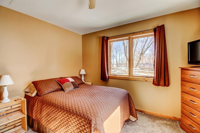 bedroom featuring a ceiling fan, baseboards, and light colored carpet