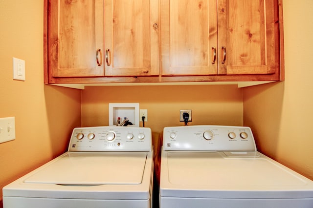 laundry room with cabinet space and washing machine and clothes dryer