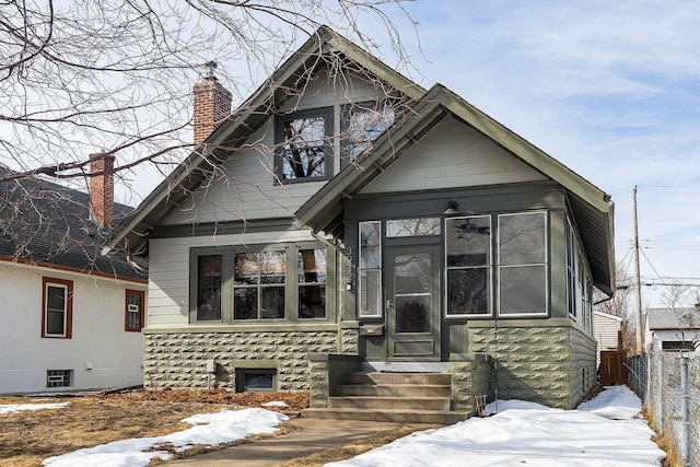 view of front of property with fence, a chimney, and entry steps