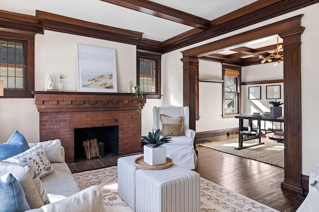 living room featuring wood finished floors, ornate columns, coffered ceiling, ornamental molding, and beamed ceiling