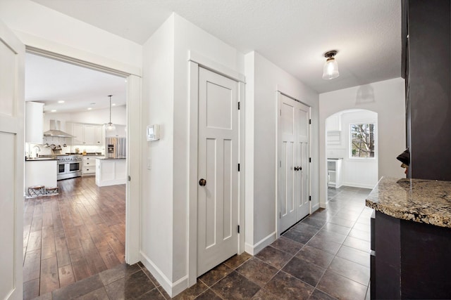 2650 Fox St, Orono, MN 55391 - hallway with arched walkways, baseboards, and a sink