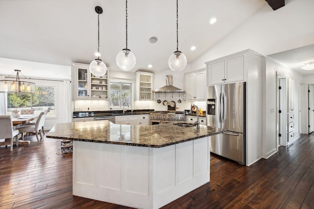 2650 Fox St, Orono, MN 55391 - kitchen featuring appliances with stainless steel finishes, wall chimney exhaust hood, a sink, tasteful backsplash, and vaulted ceiling