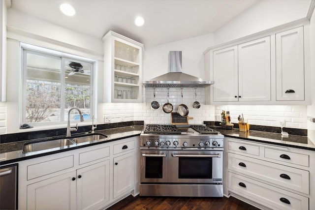2650 Fox St, Orono, MN 55391 - kitchen featuring appliances with stainless steel finishes, wall chimney exhaust hood, a sink, dark stone countertops, and white cabinetry