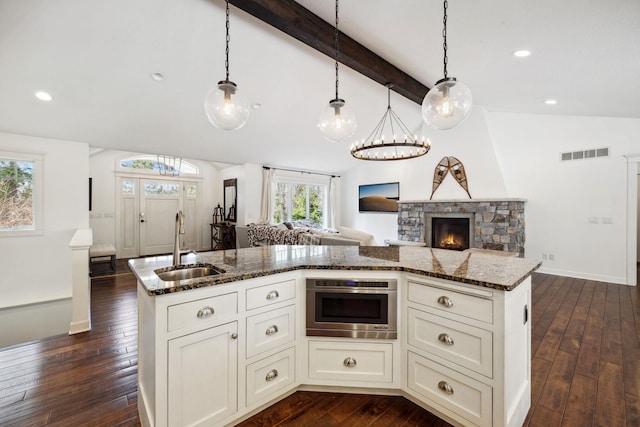 2650 Fox St, Orono, MN 55391 - kitchen with a sink, open floor plan, dark wood-style flooring, dark stone counters, and recessed lighting