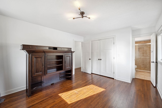 2650 Fox St, Orono, MN 55391 - unfurnished bedroom featuring dark wood-style floors, baseboards, and a closet