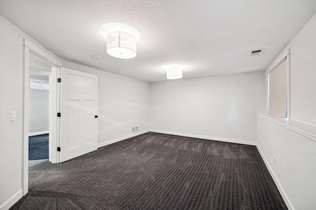 2650 Fox St, Orono, MN 55391 - unfurnished room featuring dark colored carpet, baseboards, and a textured ceiling