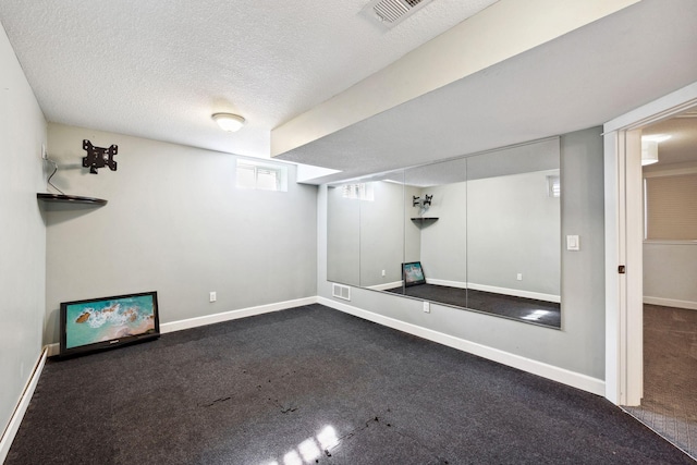 2650 Fox St, Orono, MN 55391 - below grade area featuring dark colored carpet, baseboards, and a textured ceiling