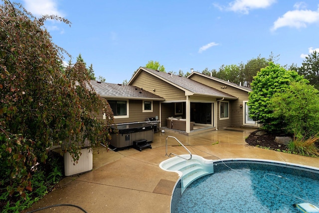 2650 Fox St, Orono, MN 55391 - rear view of house with a patio, an outdoor pool, a hot tub, and roof with shingles