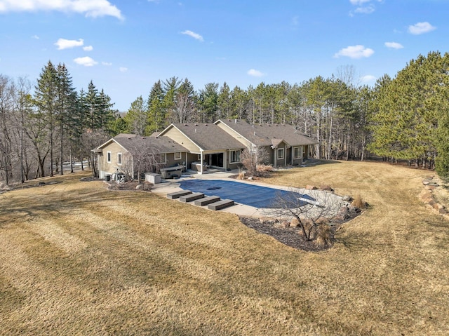 2650 Fox St, Orono, MN 55391 - back of house featuring a covered pool, a lawn, and a patio