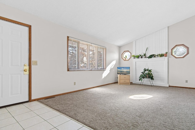 interior space featuring vaulted ceiling and light colored carpet