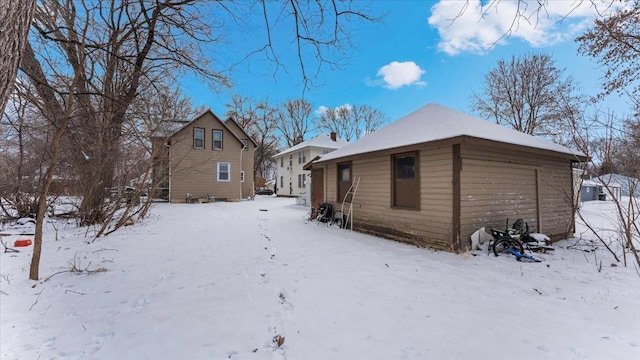 view of snow covered rear of property