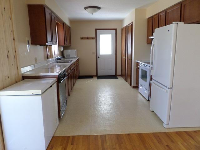 kitchen featuring light countertops and white appliances