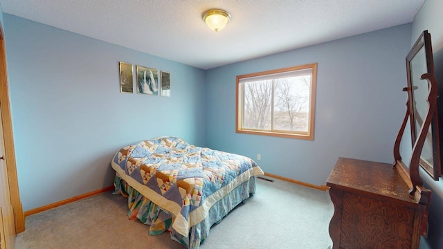 bedroom featuring carpet and a textured ceiling