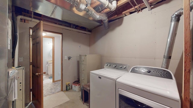 clothes washing area with washer and clothes dryer