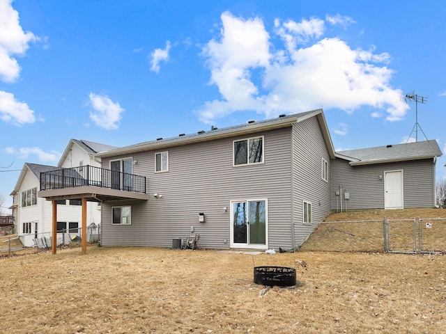 back of property featuring a wooden deck, a fire pit, and central air condition unit