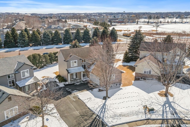 snowy aerial view with a residential view