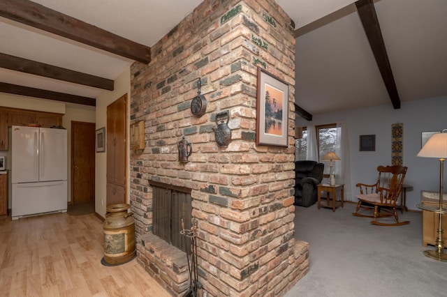 unfurnished living room featuring a fireplace, light hardwood / wood-style floors, and beam ceiling