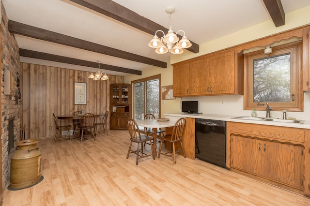 kitchen featuring pendant lighting, sink, light hardwood / wood-style flooring, dishwasher, and a chandelier