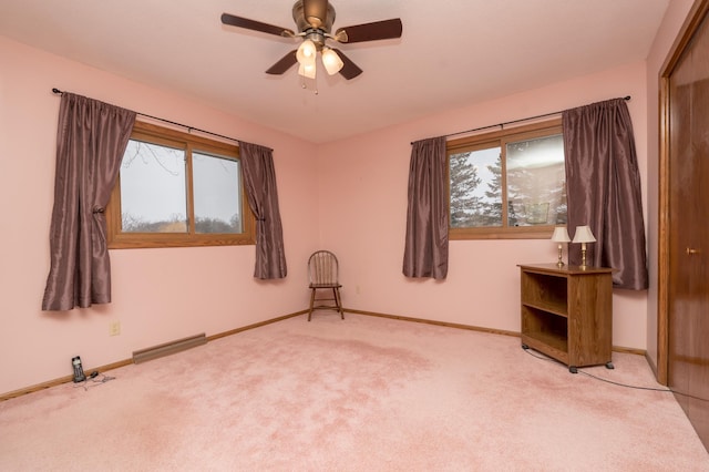 carpeted spare room with ceiling fan