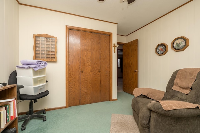 sitting room featuring ceiling fan, ornamental molding, and carpet floors