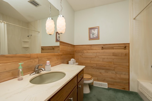 bathroom featuring vanity, a shower with curtain, wooden walls, and toilet