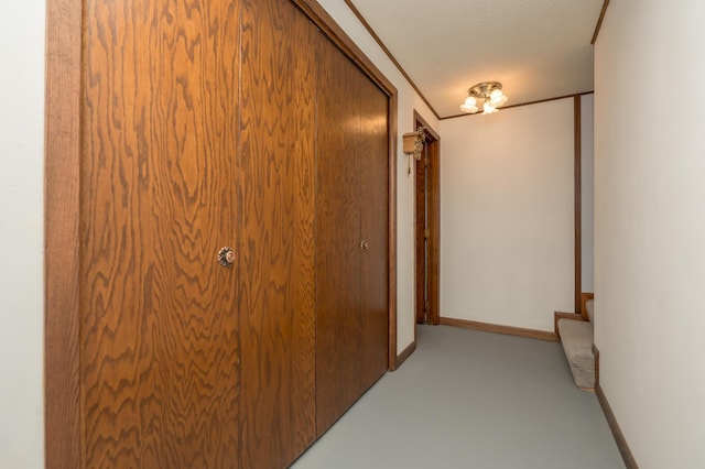 hall featuring ornamental molding and a textured ceiling