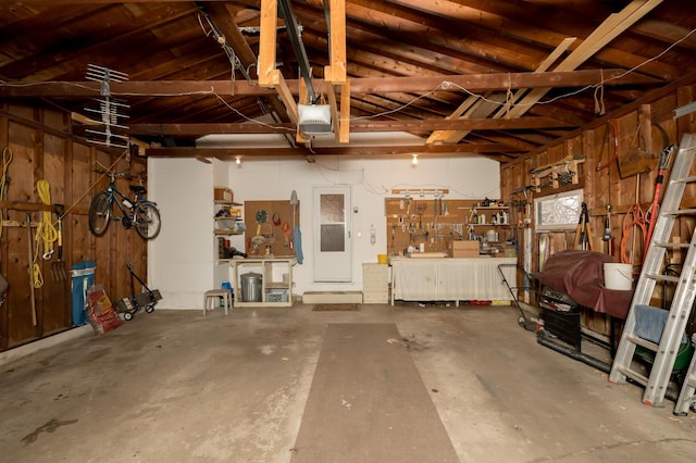 garage featuring a garage door opener and a workshop area