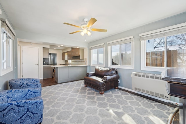 interior space featuring radiator, ceiling fan, and baseboards