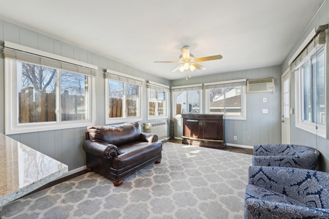 sunroom featuring a wall unit AC, ceiling fan, and an AC wall unit