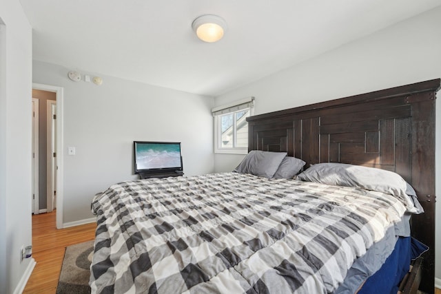 bedroom featuring light wood-style flooring and baseboards