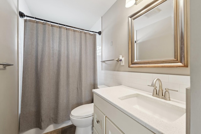 full bathroom with tile walls, a shower with shower curtain, toilet, wainscoting, and vanity