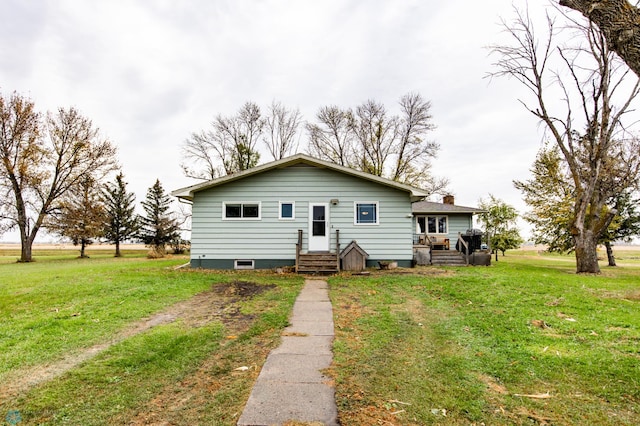 view of front of property featuring a front yard and a wooden deck