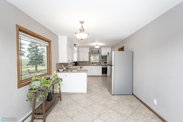 kitchen featuring a sink, pendant lighting, white cabinetry, stainless steel appliances, and backsplash