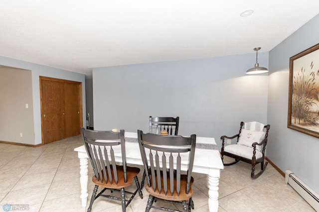 dining space featuring a baseboard radiator, baseboards, and light tile patterned floors