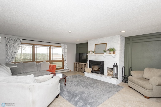 living room featuring a fireplace, light tile patterned flooring, and a textured ceiling