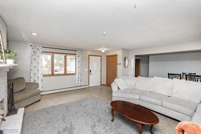 living room with a fireplace, a baseboard heating unit, light tile patterned flooring, and a textured ceiling