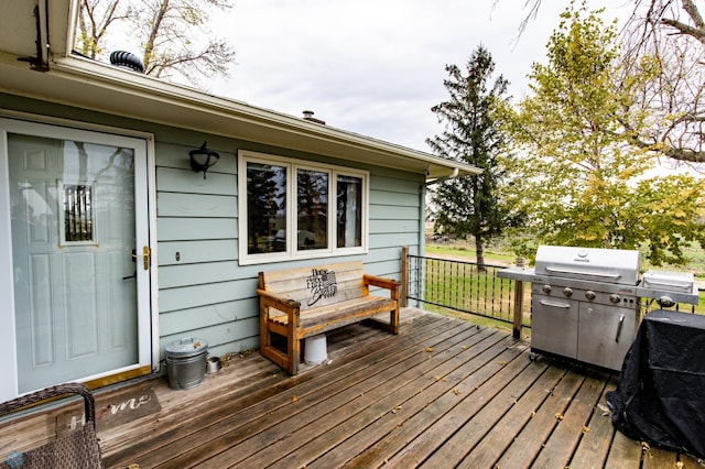 wooden deck with a grill