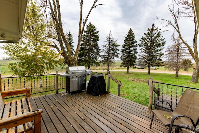 deck featuring area for grilling and a lawn