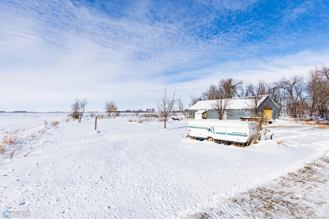 snowy yard with a garage