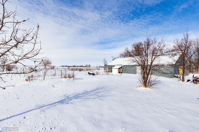 yard layered in snow with a garage