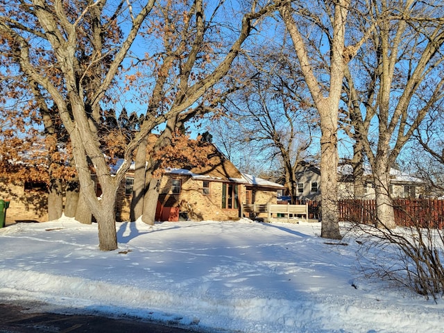 snowy yard with fence and a wooden deck