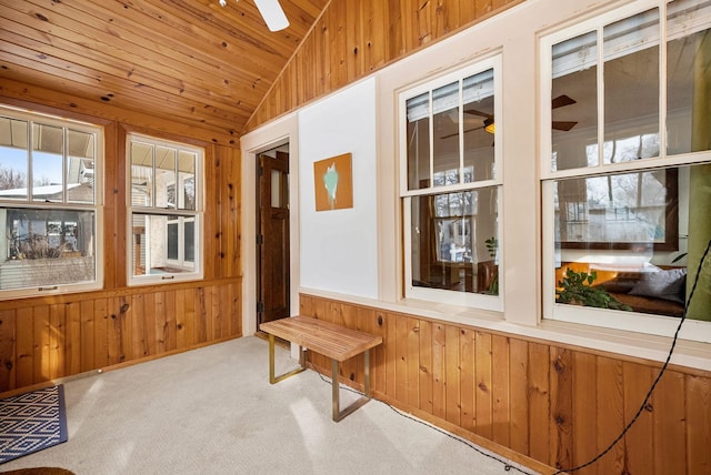 unfurnished sunroom with ceiling fan, lofted ceiling, and wooden ceiling