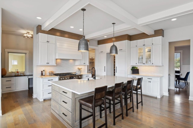4765 Augusta St, Orono, MN 55364 - kitchen with custom range hood, beam ceiling, decorative backsplash, a center island with sink, and a breakfast bar area