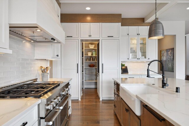 4765 Augusta St, Orono, MN 55364 - kitchen featuring custom exhaust hood, stainless steel range, backsplash, dark wood-type flooring, and white cabinetry