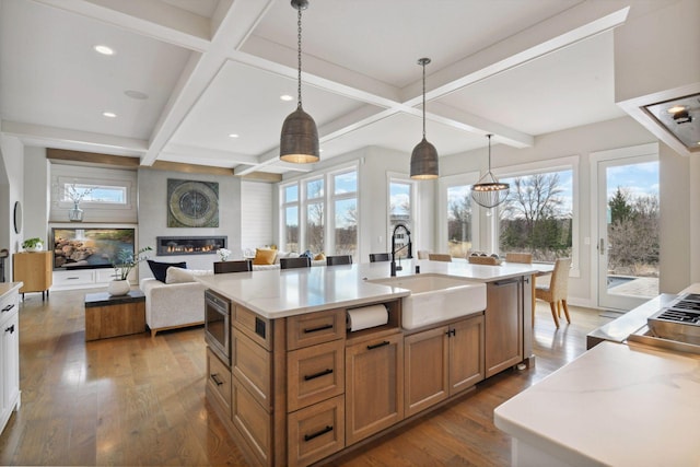 4765 Augusta St, Orono, MN 55364 - kitchen featuring stainless steel microwave, coffered ceiling, wood finished floors, brown cabinets, and healthy amount of natural light