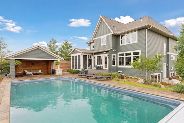 4765 Augusta St, Orono, MN 55364 - back of property with a sunroom, an outdoor pool, outdoor lounge area, a patio area, and roof with shingles
