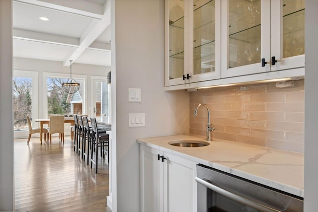 4765 Augusta St, Orono, MN 55364 - indoor wet bar featuring beamed ceiling, backsplash, dishwasher, wood finished floors, and pendant lighting
